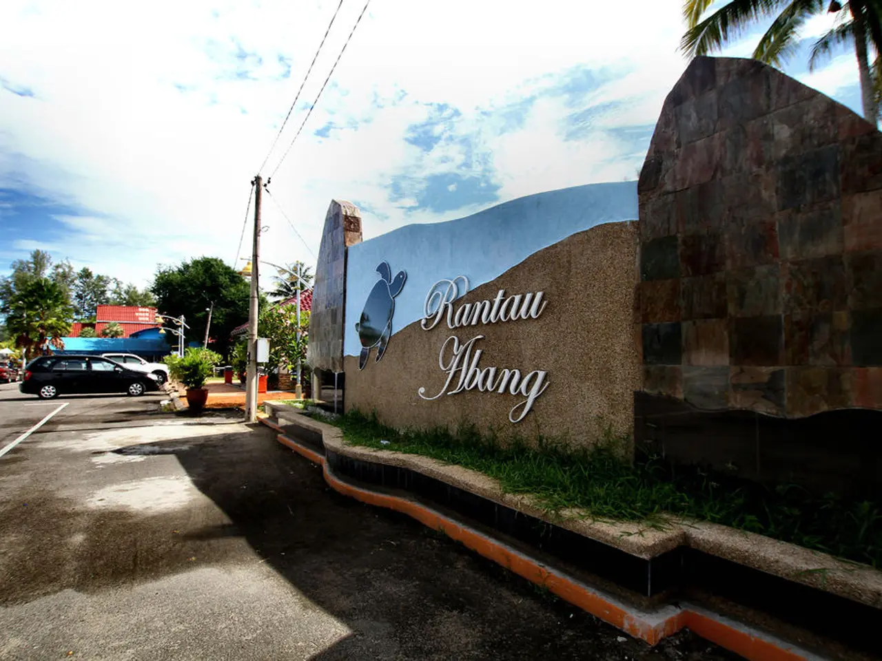 In the image we can see there are many vehicles on the road. Here we can see the wall, on the wall...