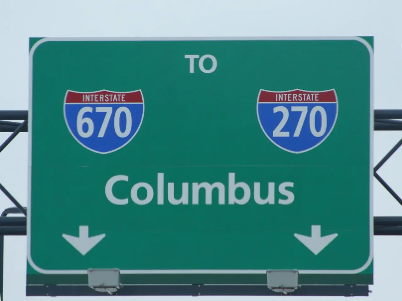 In this image we can see a green color signboard with some numbers and text written on it, and it...