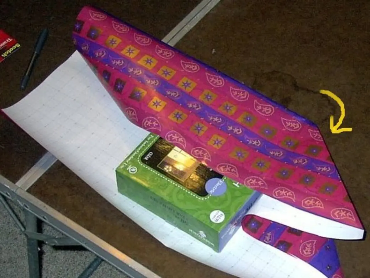 In this image there is one table on the table there is one chart, box, book, pen. And at the bottom...