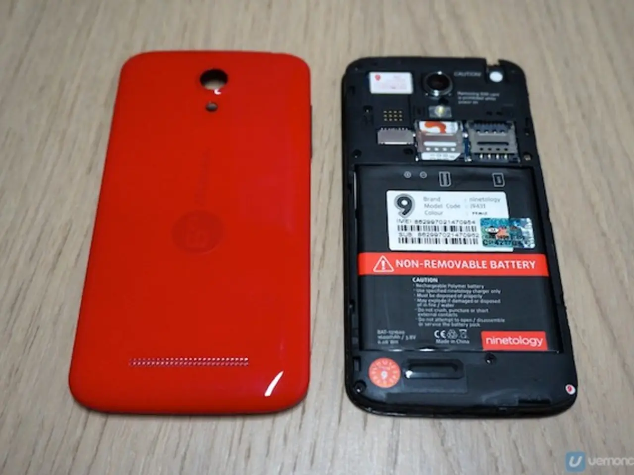 In this image there is a mobile phone with opened back panel.