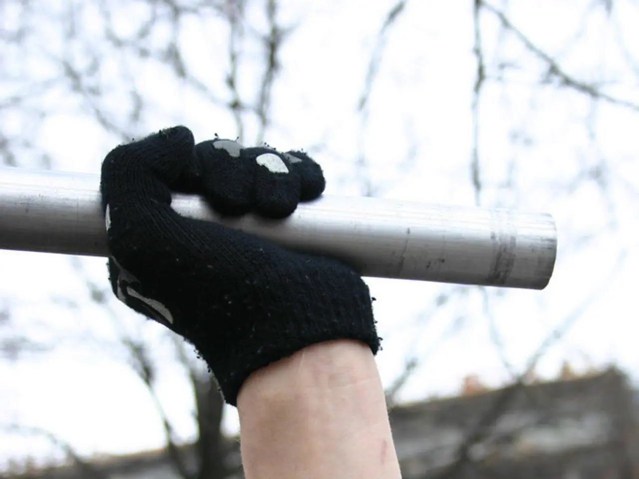 This is a zoomed in picture. In the center we can see the hand of a person wearing black color...