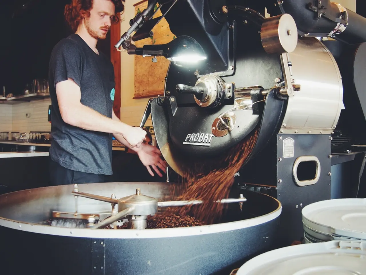 There is a man standing and holding a tool. We can see machine and objects. In the background we...