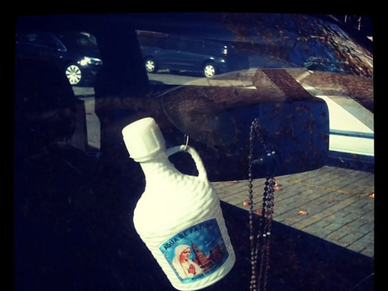 This image contains car, chain, bottle and road.