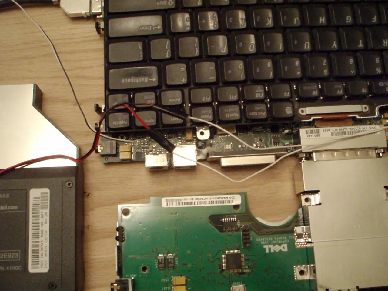 In this picture, there are devices and a keyboard placed on the table.