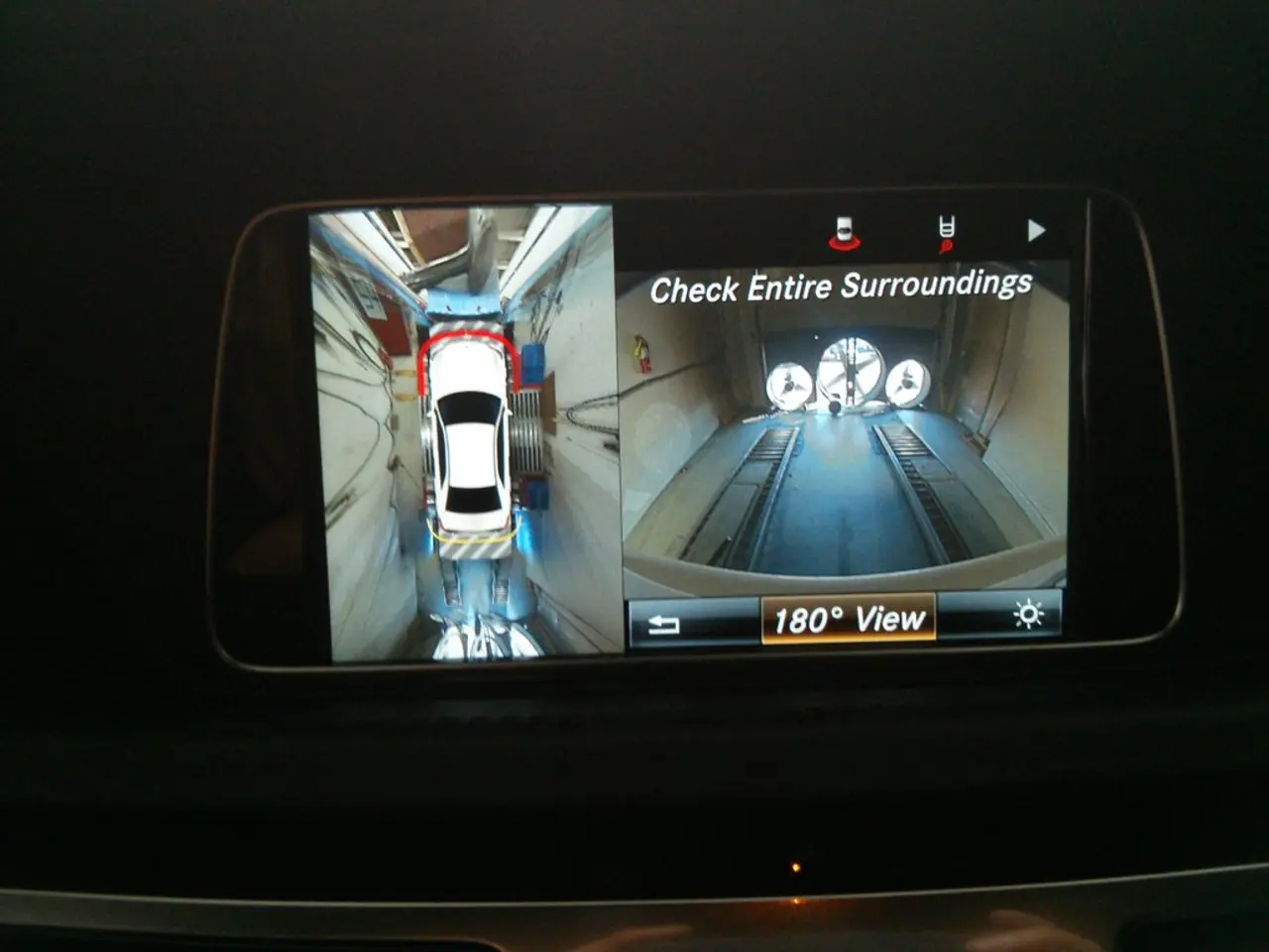 In this picture there is a phone in the center of the image, in which there is a car image, it...