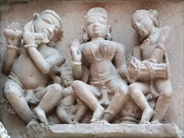 In this image I see 4 sculptures on the wall.