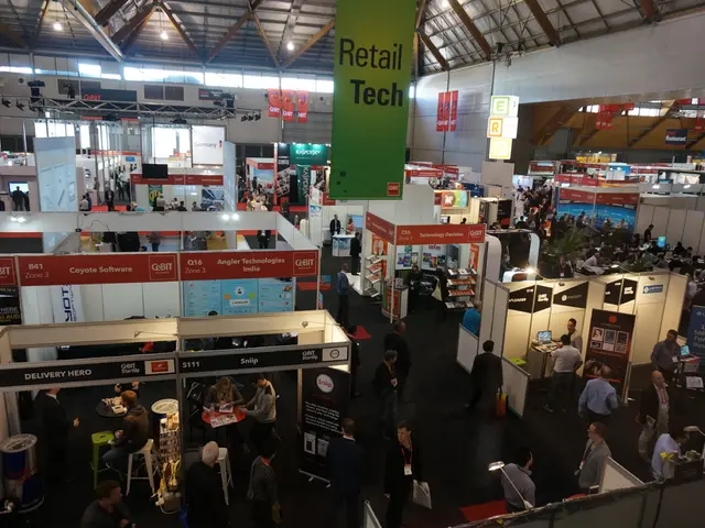 In this image we can see persons, stores, chairs, tables, computers, advertisements, tents, lights...