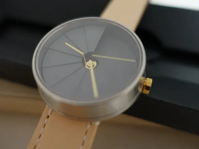 In this image I can see the watch. Background is in black and brown color.