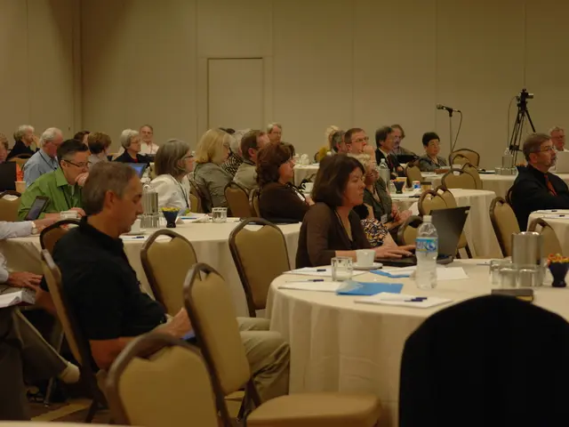 It is a conference, many people are sitting and paying attention towards something, there are many...