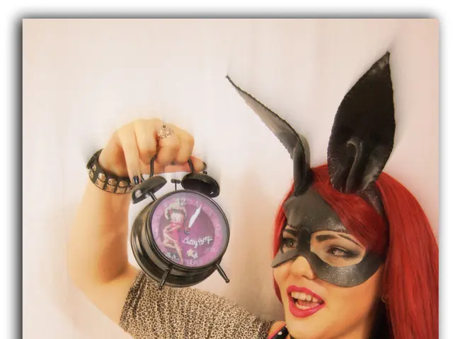 In this image I can see a woman wearing a mask and holding an alarm clock.
