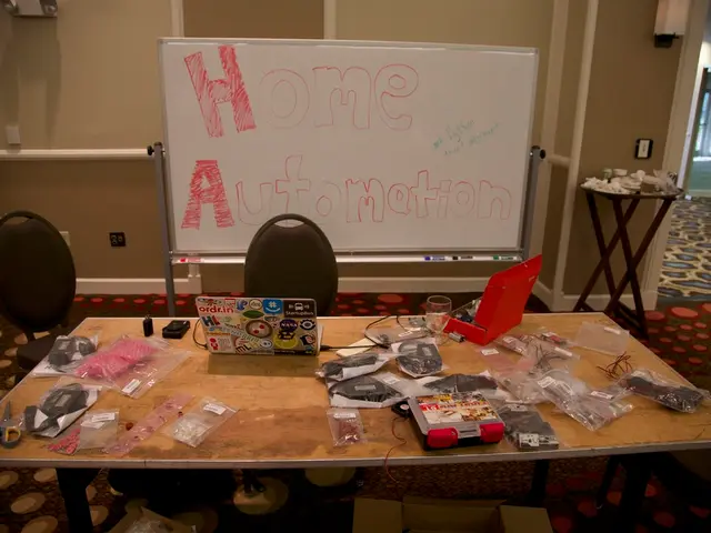 In this image there is a table and in that table there is laptop , scissor , covers , paper , glass...