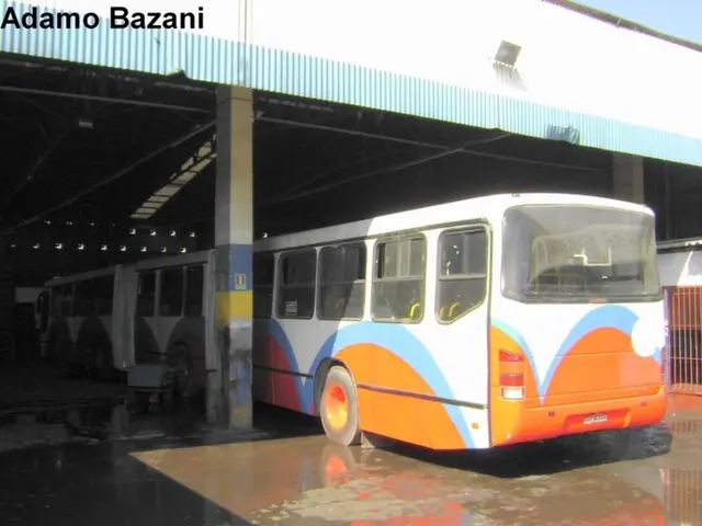 In this picture I can see a bus, there are iron grilles, there is a shed, and there is a watermark...