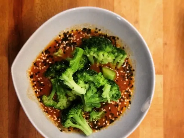 In this image we can see food in a bowl which is on a platform.