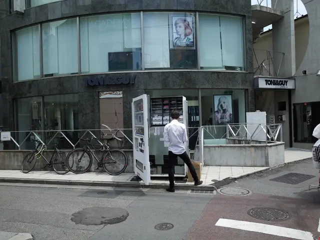 This is a road. Here we can see one woman riding a bicycle. We can see one man standing near to a...