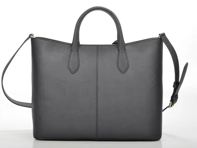 In this picture we can see a bag with belt and strap to it.