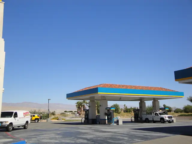 In this picture we can see petrol pump. On the right there is a white color van which is standing...