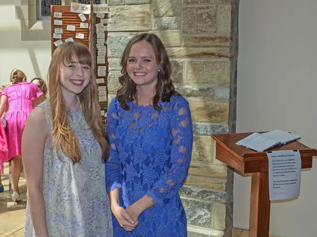 In this picture we can see two ladies one in blue dress and other in ash color dress and beside...