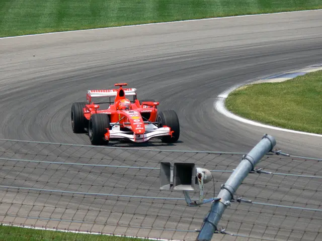 There is a vehicle on the road. This is grass and there is a mesh.